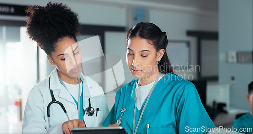 Image of Team of doctors, discussion and women on tablet in hospital for research, report advice and telehealth. Healthcare, clinic and people talking on digital tech for medical service, results and meeting