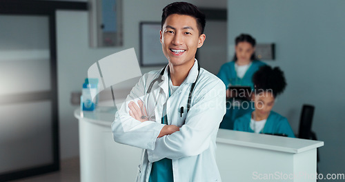 Image of Happy, doctor arms crossed and Asian man, nurse or surgeon with career smile, job experience or pride. Hospital portrait, medical cardiology and professional healthcare worker for clinic support