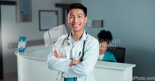 Image of Happy, doctor arms crossed and Asian man, nurse or surgeon with career smile, job experience or pride. Hospital portrait, medical cardiology and professional healthcare worker for clinic support
