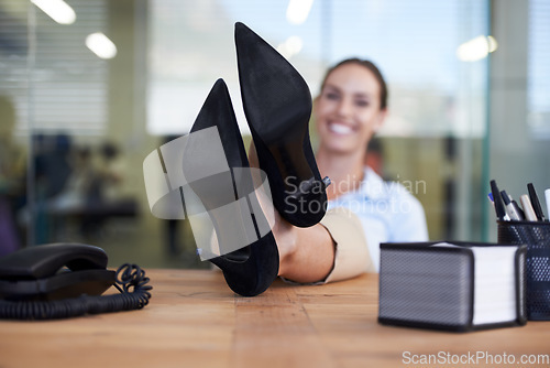 Image of Woman, feet and relax on desk in office with smile, pride and done with goal, relief or fashion at finance agency. Person, employee and happy with shoes on table, finished or achievement in workplace