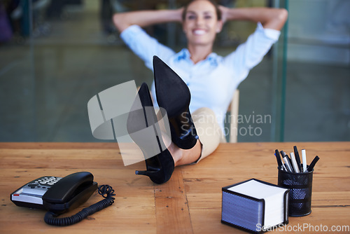 Image of Woman, shoes and relax on table in office for smile, pride or done with goal, relief or portrait at finance agency. Business person, employee or happy for feet on desk, finished or achievement at job