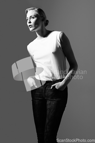 Image of Woman, black and white for classic fashion, retro or aesthetic by gray background with light. Isolated model thinking, edgy outfit or trendy clothes with vintage style, lady or art ideas in studio