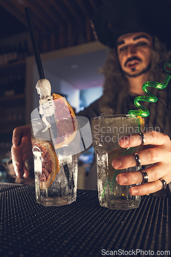 Image of Bartender served amazing Halloween themed drinks.