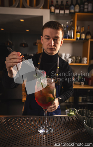 Image of Barmen is decorating cocktail