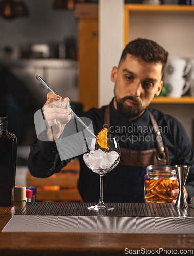 Image of Barman is decorating cocktail