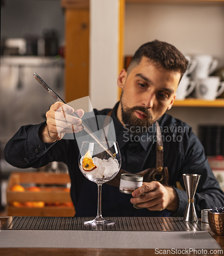 Image of Expert barman is making cocktail