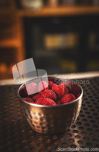 Image of Raspberries in metal bowl.