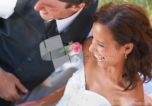 Image of Couple, laughing and love on wedding day in outdoors, together and excited for marriage and commitment. Happy people, romance and union or relaxing on grass, loyalty and humor and fun in partnership