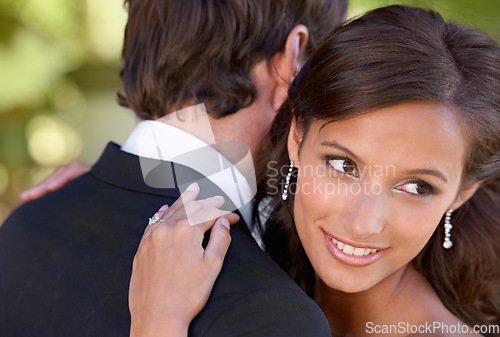 Image of Couple, happy and embrace on wedding day for love, support and together for marriage and commitment. People, romance and hugging at outside ceremony, loyalty and smiling for devotion in outdoors