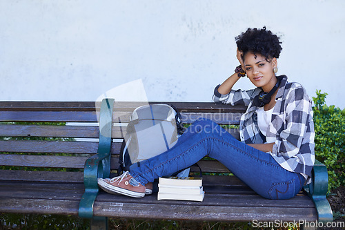 Image of Woman, portrait and student on bench with book for university study, education or reading. Female person, face and smile at college campus outdoor for knowledge, scholarship or research literature