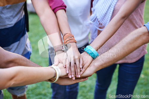 Image of People, teamwork and hands together of friends outdoor for support, solidarity or mission of success, synergy or winning. Closeup, community group or collaboration at park for trust, kindness or help