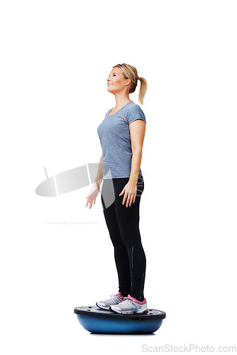 Image of Woman, balance ball and standing for training, exercise or workout on white studio background. Active female person or athlete on half round object for fitness, health and wellness mockup space