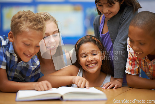 Image of Children, teacher and reading a book in classroom for knowledge, learning or education with happiness. Group, student and woman at school with study, textbook and smile with diversity at college