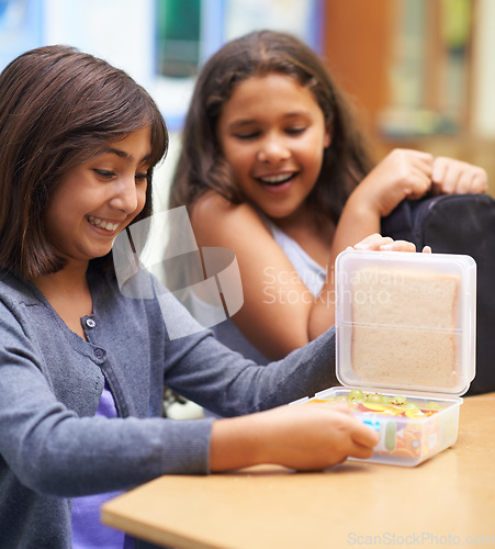 Image of Happy girl, friends and student with lunchbox for eating meal, break or snack time in classroom at school. Young kids or elementary children smile for container, food or fiber and nutrition in recess