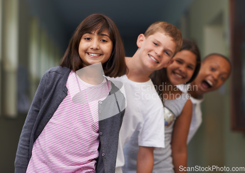 Image of Girl, portrait and friends in line at school with confidence and pride for learning, education or knowledge. Student, people and face with smile in building or hallway before class or ready to study