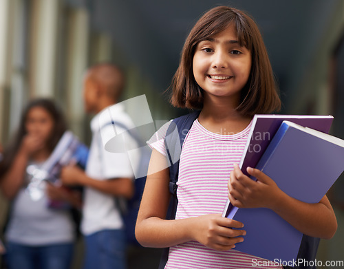 Image of Girl, portrait and happy in corridor of school with backpack or books for learning, education or knowledge. Student, person and face with smile in building or hallway before class or ready to study