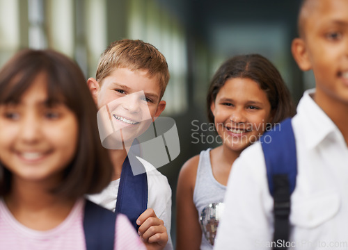 Image of Boy, portrait and friends in corridor or happy with backpack or pride for learning, education or knowledge. Student, people and face with smile in building or hallway before class or ready to study