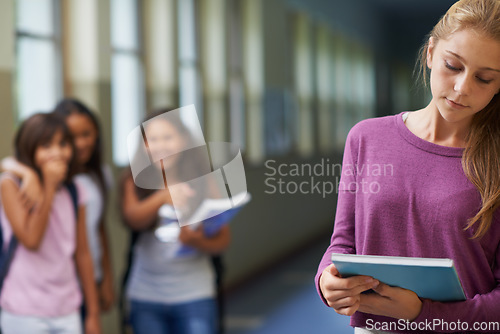 Image of Girl, school and sad student bullying victim feeling depression, lost or stressed in hallway or corridor. Kids laughing, depressed child or lonely female learner with anxiety, abuse trauma or fear