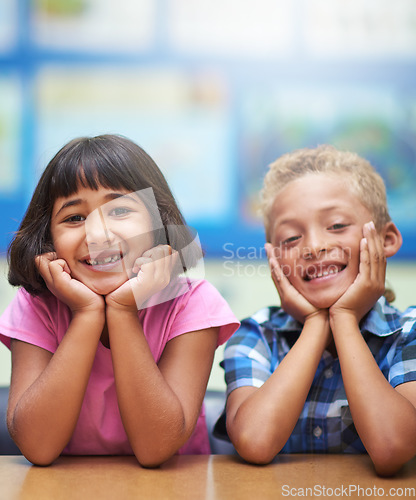 Image of Students, children and portrait or happy in classroom for learning, knowledge or education at desk. Kids, face and smile at academy or school with confidence or pride for development and diversity