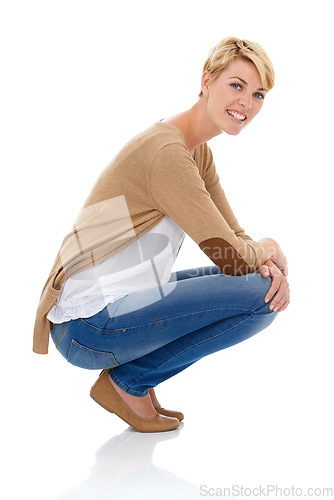 Image of Happy woman, portrait and sitting in casual fashion or pose isolated on a white studio background. Young female person, model or blonde smile with denim jeans or clothing in relax on mockup space