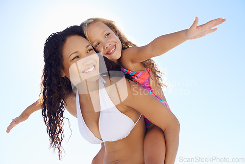 Image of Happy mother, child and piggyback on beach for bonding, vacation or outdoor holiday weekend together. Mom, kid or daughter smile in sun for love, support or summer break with blue sky background