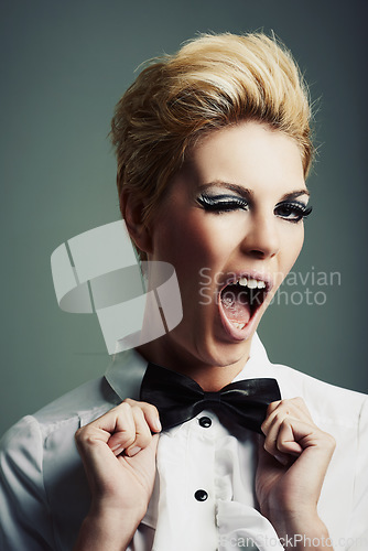 Image of Portrait, bow tie or woman with fashion, wink or vintage clothes on grey background in studio. Classy aesthetic, edgy female model or confident girl isolated with retro style, beauty and cool makeup