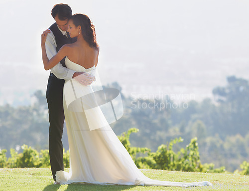 Image of People hug, bride and groom at wedding, outdoor in nature for social event with love and commitment. Man, woman and marriage, couple celebrate with trust and care together on hill with life partner