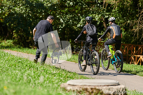 Image of A professional videographer skillfully captures the joyous journey of a couple on bicycles through the park, blending cinematic expertise with the natural allure of outdoor adventure