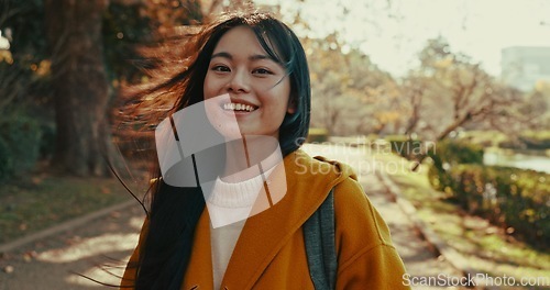 Image of Japanese, portrait and woman with smile in park for travel on vacation, adventure and explore path with trees. Gen z, student and happy walk on holiday in nature, forest and trail in Kyoto woods