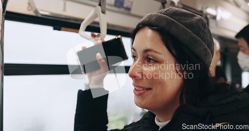 Image of Woman, smartphone and thinking in train, travel and hand holding handle for balance, safety and memory. Girl person and phone with ideas, smile or public transport on railway infrastructure in Tokyo