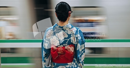 Image of Japan woman, travel and train station in kimono and public transportation on metro bullet in city. Person, motion blur or traditional clothes by fast vehicle or subway in tokyo on urban adventure