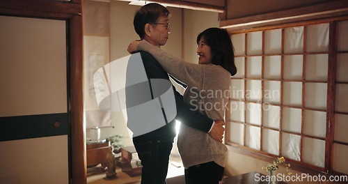 Image of Senior couple, dancing and home with love, support and happiness with weekend break, hug and bonding together. Japan, man and woman embrace, apartment and cheerful with peace, movement and joyful