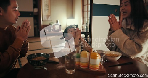 Image of Family, food and dinner in home with praying for gratitude, mindfulness and thankful at dining room table. Japanese, parents and girl child with prayer in lounge for lunch, brunch or breakfast