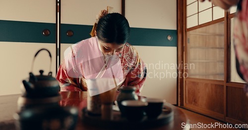 Image of Woman in Japanese tea house with bow, kimono and relax with mindfulness, respect and gratitude. Girl at calm tearoom for matcha drink, zen culture and ritual at table for traditional ceremony in home