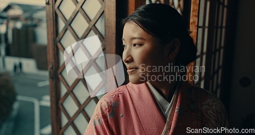 Image of Japanese woman, window view and kimono for traditional style in home, ideas or remember by street. Girl, person or thinking with vision, happy memory or mindfulness in morning at apartment in Tokyo