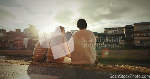 Image of Friends, sitting and talking in city on sidewalk with travel, gen z and happy discussion together in japan. People, bonding and back in tokyo town on vacation and holiday with wellness by water canal