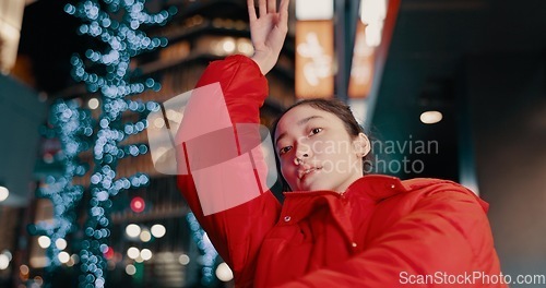 Image of Japanese, woman and portrait with dancing outdoor at night in streetwear, trendy outfit or fashion. Dancer, person and contemporary style with arm movement, performance and entertainment in the city