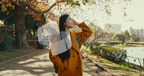 Image of Woman, thinking and walk in Japanese park with smile in woods for travel on vacation, adventure and explore path. Gen z, student and happy on holiday in nature, forest and trail with trees in Kyoto