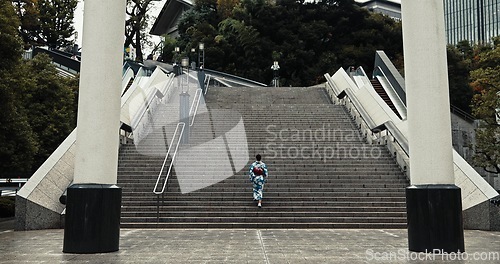 Image of Japan, woman and kimono outdoor on stairs for wellness, heritage celebration and culture in Tokyo city. Sanno Torii, person and walking on steps for travel, spiritual journey and traditional fashion