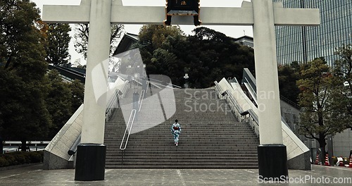 Image of Japan, woman and kimono in city on stairs for wellness, heritage celebration or culture in outdoor Tokyo. Sanno Torii, person or walking on steps for travel, spiritual journey and traditional fashion