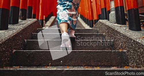 Image of Woman, shinto culture or walk by stairs in japan, spiritual path or indigenous religion in kimono. Person, traditional clothes or worship in peace, respect or back by Fushimi Inari Taisha in kyoto