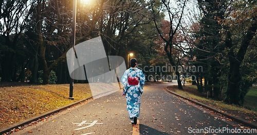 Image of Back, woman in street and Japanese clothes, travel and nature with journey through town in Kyoto. Walking outdoor, road with traditional fashion, kimono or dress, adventure and local trip on path