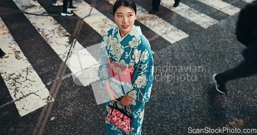 Image of Japanese, woman in traditional clothes and walk with city view and travel with journey outdoor. Fashion, adventure and urban street in Kyoto, kimono or dress for culture and style with local trip