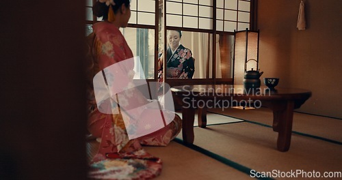 Image of Japanese, women and kimono in corridor for ceremony in chashitsu room with indigenous fashion or clothing. People, ritual and culture for temae, wellness and zen in architecture building in Tokyo