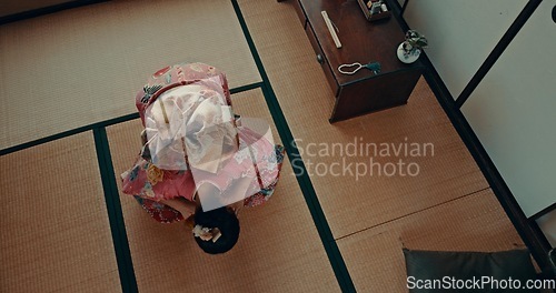 Image of Japanese woman, praying and bow in shinto religion with meditation, faith and traditional clothes on floor. Girl, person and prayer with mindfulness, zen and balance with peace, calm and mat in Tokyo