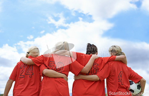 Image of Woman, hug and back of soccer team ready for sports match, game or outdoor practice with blue sky. Rear view of female person or group of football players standing in unity with ball in nature