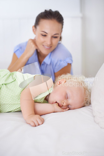 Image of Smile, sleeping and mother with baby on bed for bonding, relax and sweet cute relationship. Happy, love and young mom watching girl child, kid or toddler taking a nap in bedroom or nursery at home.