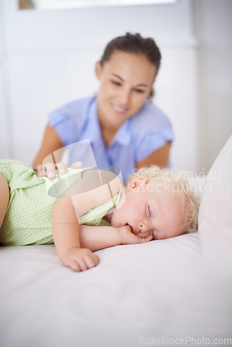 Image of Smile, sleeping and mother with baby on bed for bonding, relax and sweet cute relationship. Happy, love and young mom watching girl child, kid or toddler taking a nap in bedroom or nursery at home.