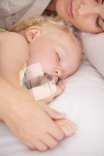 Image of Mother, baby and kid suck thumb in home, adorable and cute innocent child with parent in house. Young blonde toddler, finger and mouth of healthy little girl sleeping in bedroom together with mama