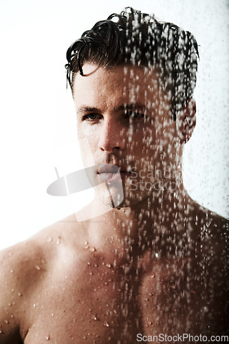 Image of Man in bathroom shower, cleaning body and relax for morning wellness, hygiene and skin routine. Grooming, skincare and face of male model with muscle washing with water, self care and calm bathroom.